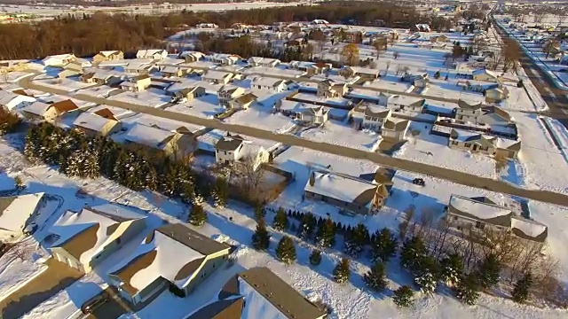 清晨空中巡视积雪覆盖的社区和郊区的房屋视频素材