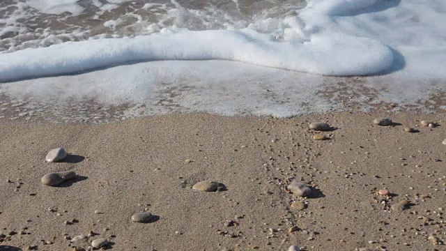 近景卵石，沙子和海浪在海滩视频素材