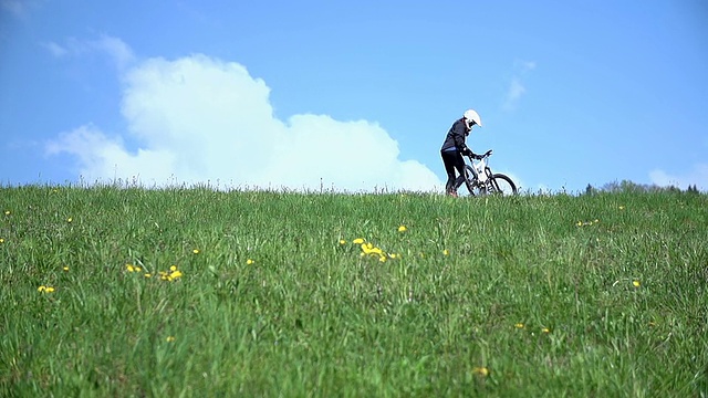 下坡的司机把自行车抬向天空视频素材