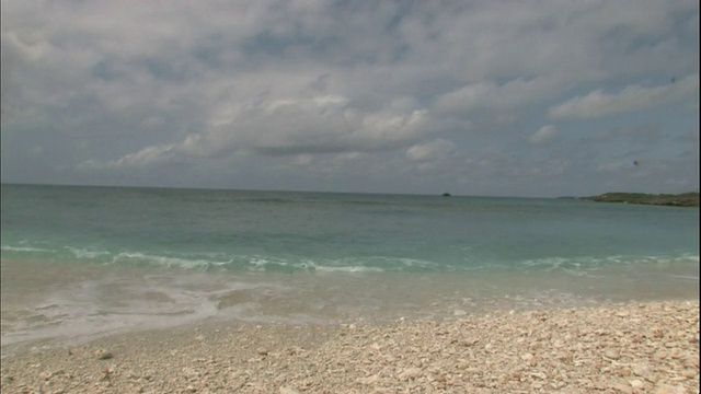 日本宫古岛(Miyakojima Island)上，轻柔的海浪冲刷着沙滩。视频素材