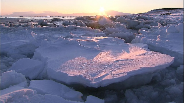 日本北海道附近的鄂霍次克海浮冰上闪耀着金色的光芒。视频素材