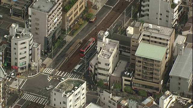 一辆Toden荒川线有轨电车在人行横道为行人停车。视频素材