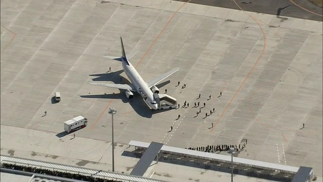 在茨城市机场，乘客们从天空航空公司的一架客机上下来。视频素材