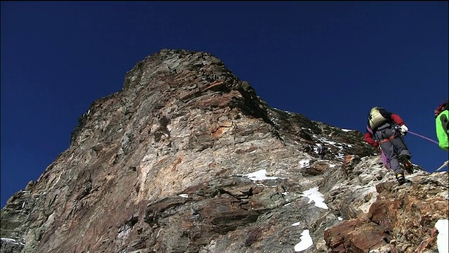 登山者在马特洪峰的多雪多石地区行走视频素材