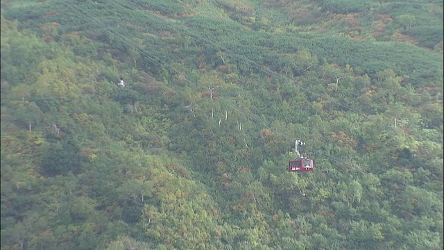 朝日山上空乌云密布，缆车载着游客前往山顶。视频素材