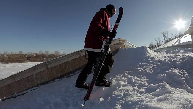 在太阳的背景下，滑雪者走到街道的山脊附近视频素材