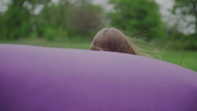 Happy Woman with Cape running Across the Green Park快乐的女人视频素材