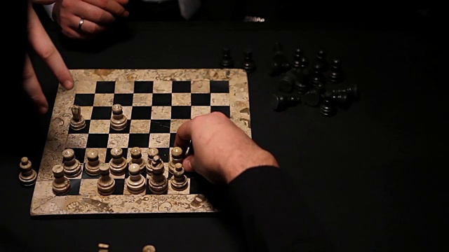 two people in suits playing chess, one game just ended, they are putting the figures into start positions for a new game .两个人穿着西装下棋，一场游戏刚刚结束，他们正在把数字放到起始位置视频素材