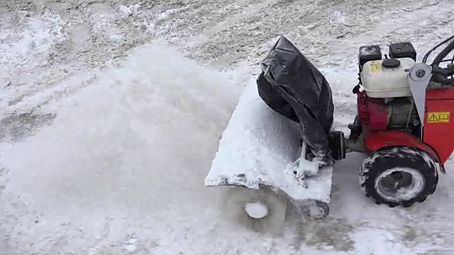 冬天吹雪机清理人行道上的积雪。FullHD视频素材