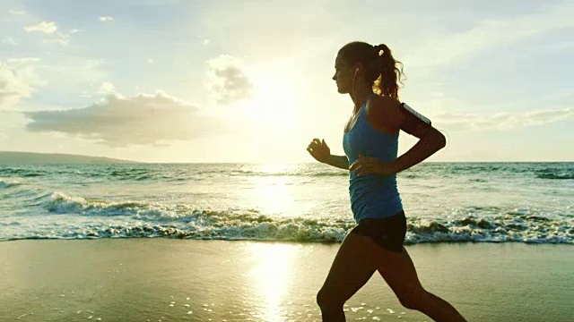 年轻女子在海滩上跑步视频素材