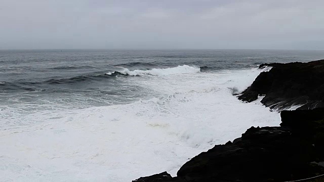 海浪冲击着黑色熔岩岩海岸，俄勒冈州的迪坡湾视频素材