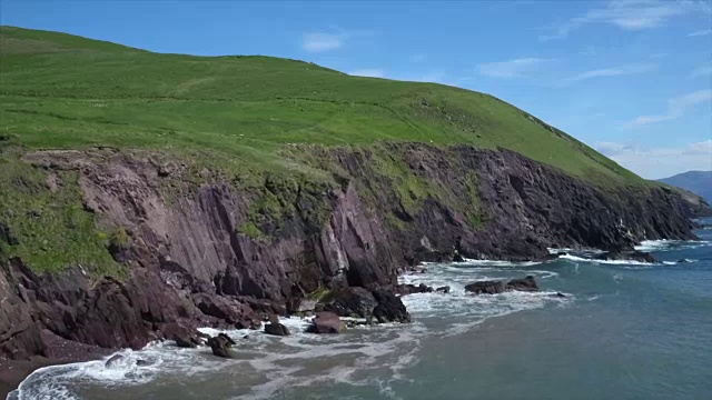 鸟瞰图的海浪冲海岸附近的岩石悬崖面视频素材