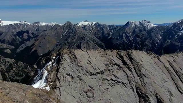 航拍:徒步旅行者正在穿越陡峭的山脊天桥视频下载