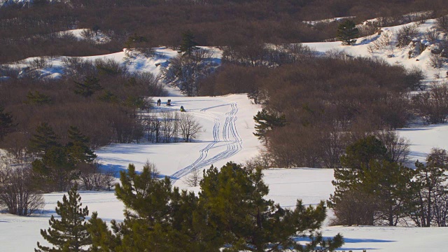 山谷里的人骑雪地摩托视频素材