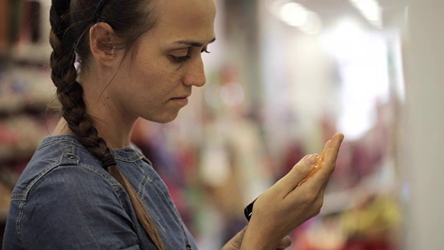 年轻迷人的女人在超市看化妆品视频素材