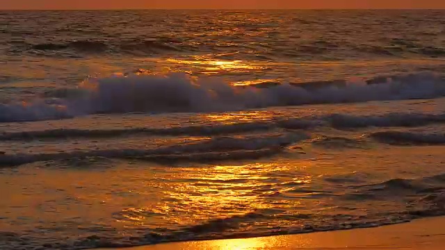 海浪在沙滩上，美丽的日落视频素材