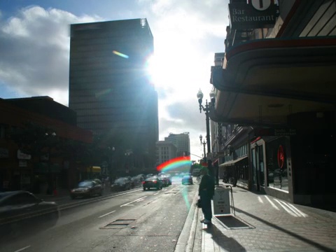 time-lapse of city street as sun glarearetime -lapse of city street with sun炫目in视频素材