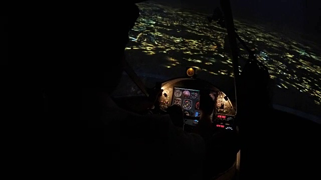 客机夜间降落机场跑道时，飞行员控制面板上的飞行数据视频素材