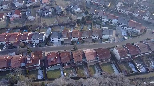 空中低空在寒冷的冬日里，飞过一个安静冰冷的郊区小镇视频素材