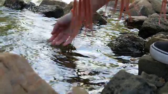 女孩把她的手移过水面，移开了她的手视频素材