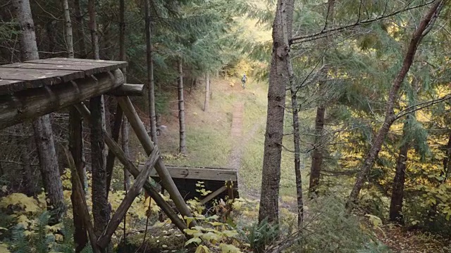 4K SLO MO:一个山地自行车手骑下斜坡的特写视频素材