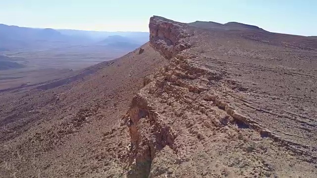 一群在沙漠岩石上爬山的山羊视频素材