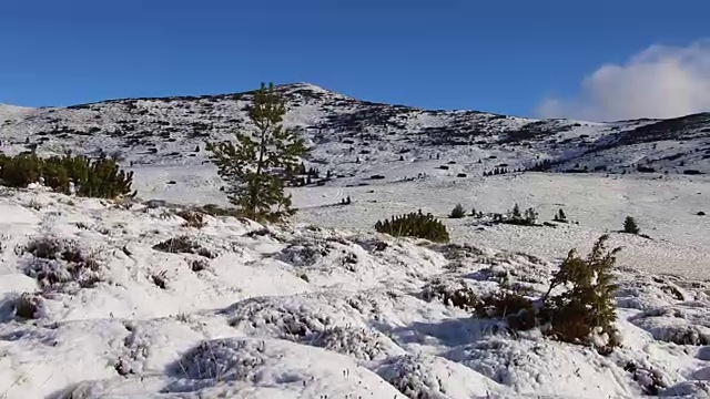 个人视角在雪山远足，徒步者行走。雪的冬天的风景。视频素材