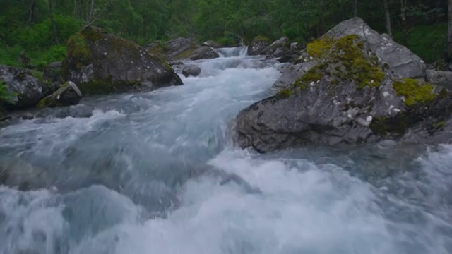 山涧在岩石和树木之间流淌。鸟瞰图视频素材