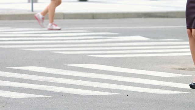 年轻苗条的女人穿着高跟鞋走在人行横道上视频素材