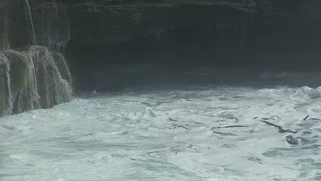 巨大的海浪在海湾与悬崖的背景视频素材