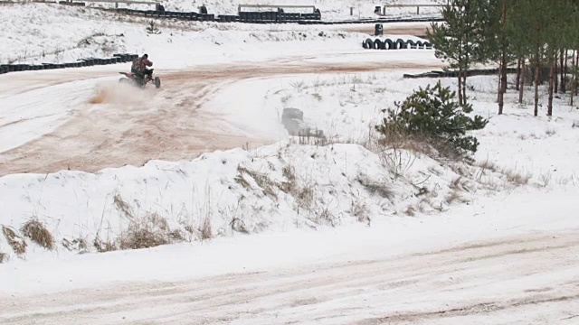 冬天的时候，他开着一辆沙滩车行驶在积雪覆盖的路上视频素材