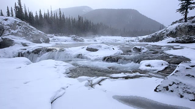 多雪的冬季河流瀑布在暴风雪视频素材