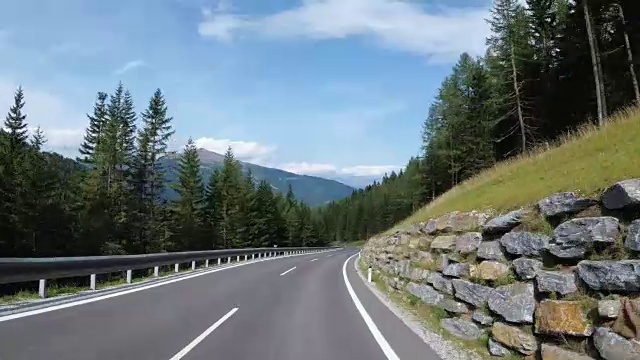 奥地利，骑摩托车的人在风景优美的山路上。第一人称视角视频素材