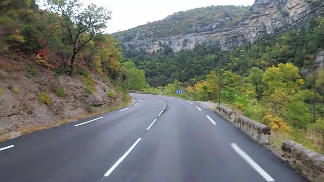 骑摩托车的人在法国美丽的风景山路上。多雨的天气。第一个人的观点视频素材