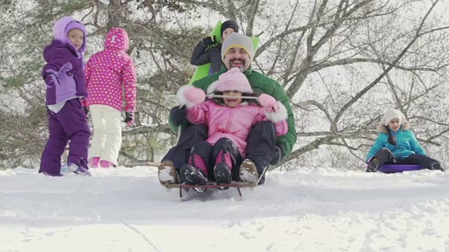 父亲和孩子们一起滑雪橇视频素材