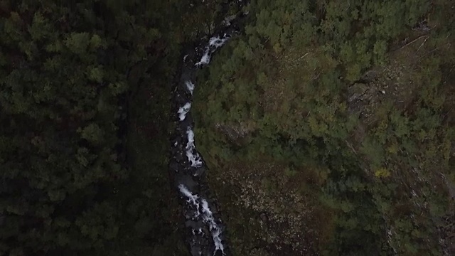 4K鸟瞰图激流瀑布通过深史诗山谷的岩石和森林视频下载