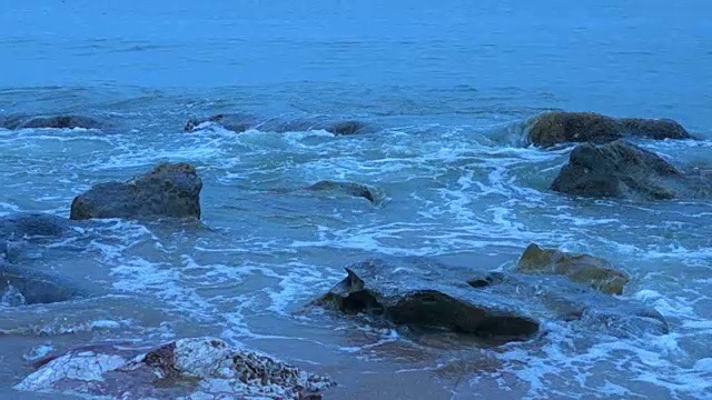 慢动作:海浪卷起白色沙滩的特写镜头视频素材