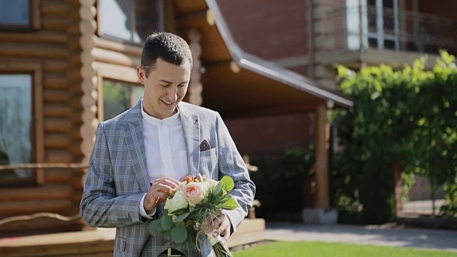 婚礼花束与美丽的鲜花在新郎的手中视频素材