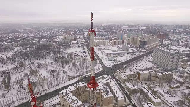 相机沿着一座现代电信塔升起，鸟瞰城市的建筑和道路视频素材