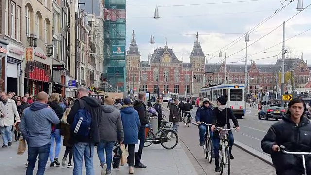 阿姆斯特丹中央火车站前的有轨电车和旅客视频素材