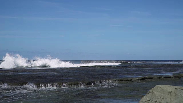 慢镜头海浪撞击海岸岩石，溅起巨大水花视频素材