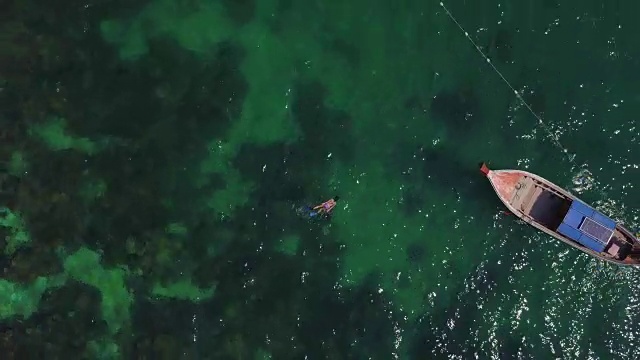 鸟瞰浮潜，长尾船和岩石海岸与水晶清澈的绿松石水Koh Kla, Koh Lipe, Satun，泰国视频素材