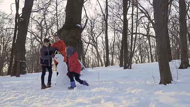 酷酷的小男孩完成了雪人和离开男孩在慢镜头视频素材