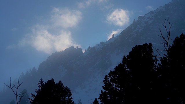 冬天在冰雪覆盖的岩石山脉徒步旅行视频素材