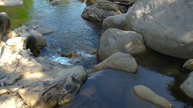 山河中的大石头和岩石。热带森林中的高山瀑布和石质河流。湍急的河水在巨石之间流动，形成瀑布视频素材