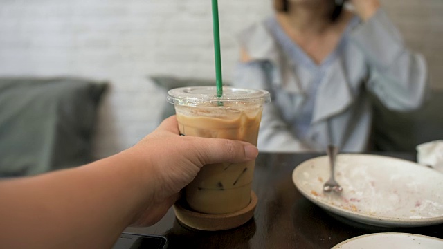 咖啡馆里拿着饮料的女人的中间部分视频素材