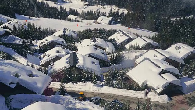 从滑雪缆车到山上小屋被雪覆盖的屋顶的景色视频素材