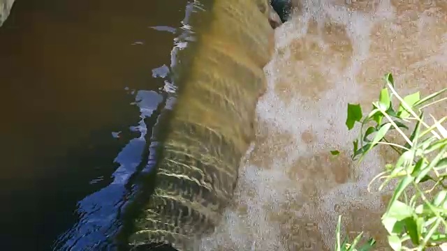 雨后日常生活视频。水从城里的一条运河流向大海。在城市排水和防止洪水泛滥的概念。视频素材