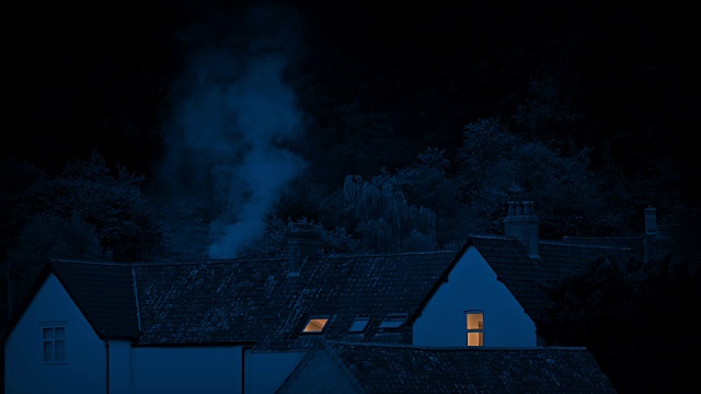 The Smoke Rising From Houses In The Countryside At Night .农村夜间房屋冒烟视频素材