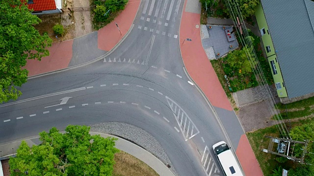 两辆车从城市的十字路口经过，鸟瞰图视频素材